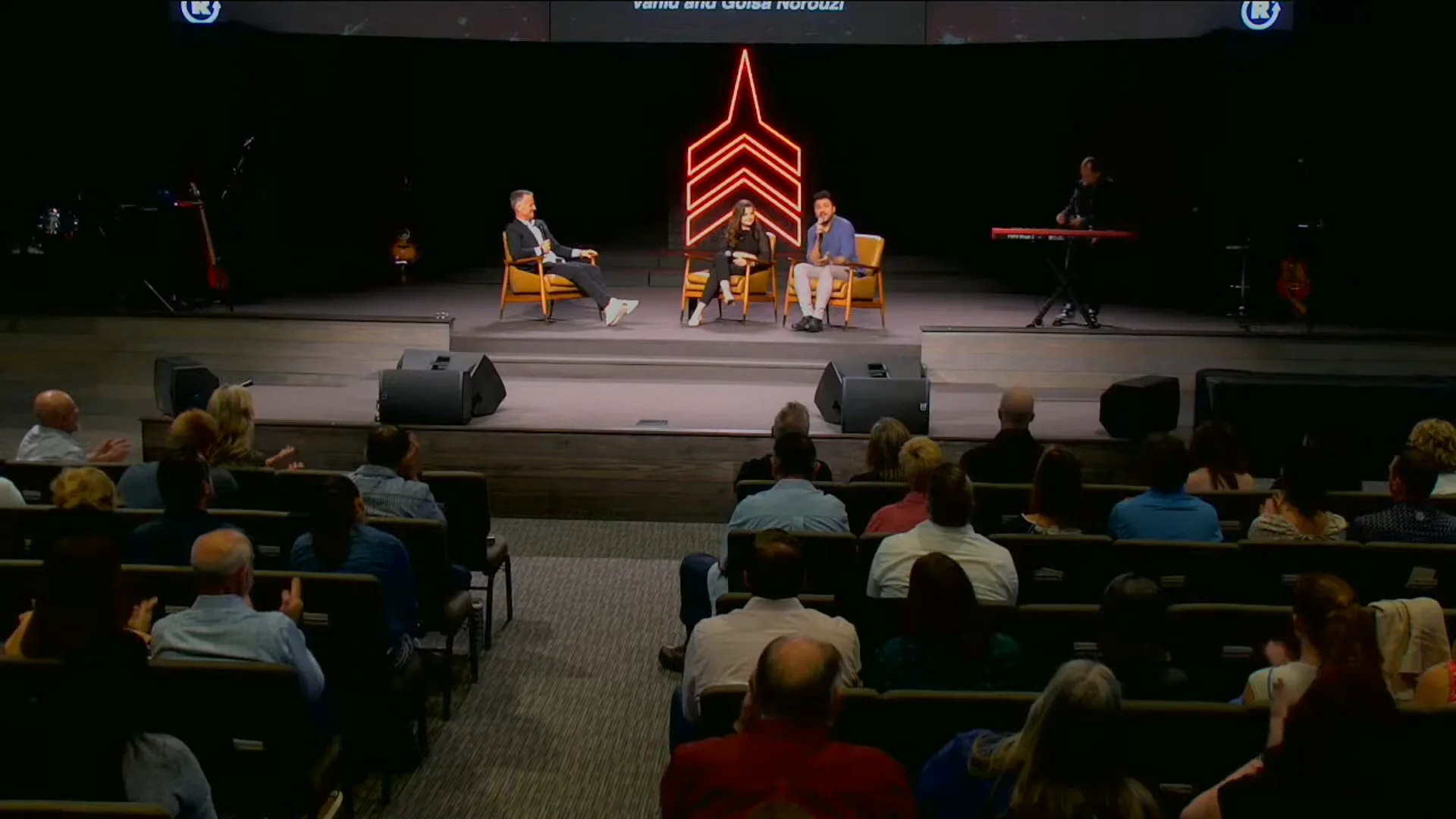 Vahid and Golsa Norouzi teaching to a full auditorium at Restoration Church